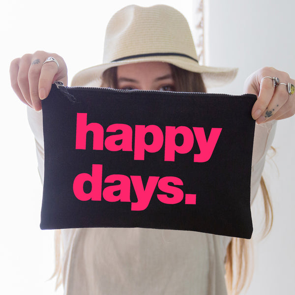an oversized black cotton canvas pouch with the slogan 'happy days' printed in neon pink