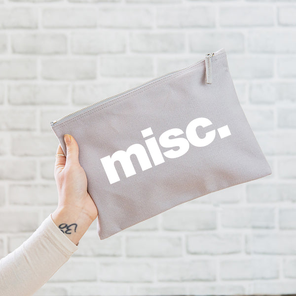 A really useful oversized canvas pouch printed with the slogan 'misc' in white