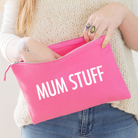 A really useful oversized pink canvas pouch printed with the slogan 'mum stuff' in white