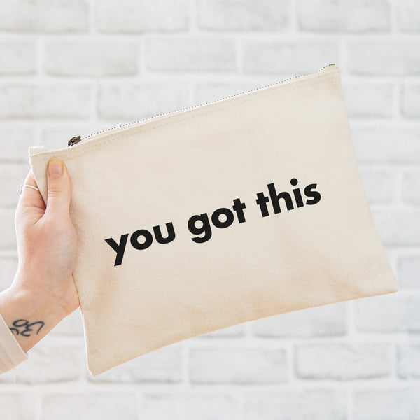 an oversized natural coloured pouch bag printed with the slogan 'you got this' in black