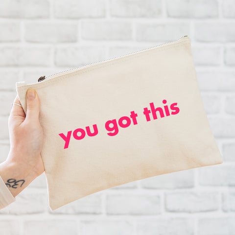 an oversized natural coloured pouch bag printed with the slogan 'you got this' in neon pink