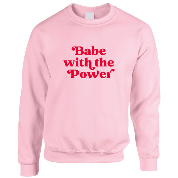 David Bowie Goblin King Labyrinth Slogan Sweatshirt. Light pink jumper with a bold 'Babe with the power' design printed in bright red