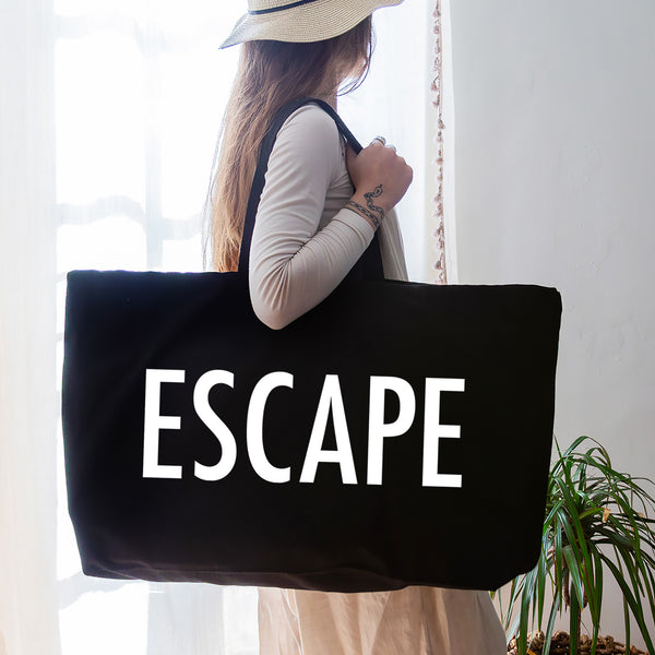 black oversized tote bag with large white escape text