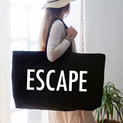 black oversized tote bag with large white escape text