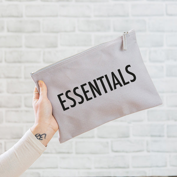 a really useful oversized grey pouch printed in black with the slogan 'essentials'
