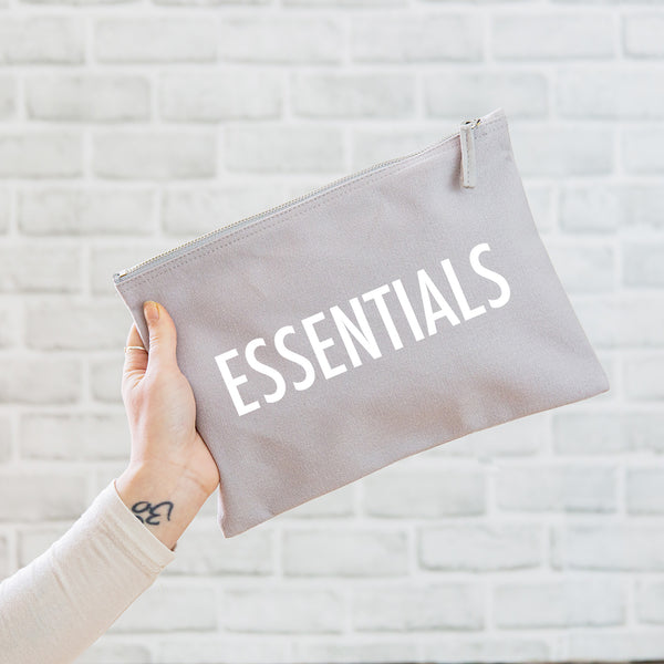 a really useful oversized grey pouch printed in white with the slogan 'essentials'