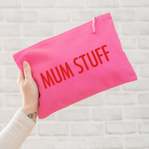 A really useful oversized pink canvas pouch printed with the slogan 'mum stuff' in red