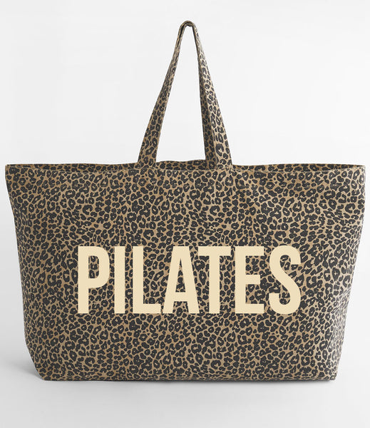 Leopard print tote bag with 'PILATES' in cream on a white background