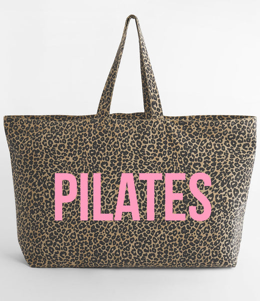 Leopard print tote bag with 'PILATES' in pink on a white background