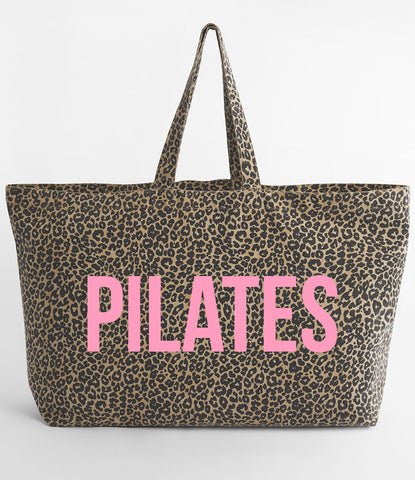 Leopard print tote bag with 'PILATES' in pink on a white background