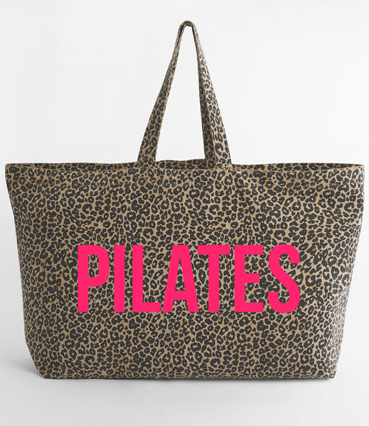 Leopard print tote bag with 'PILATES' in neon pink on a white background