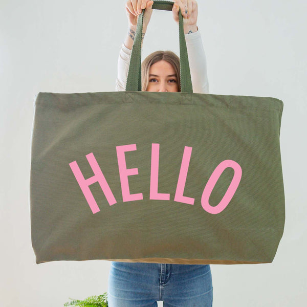 Really Big Oversized Olive Green Tote Bag With the Word 'HELLO' Printed In Big Letters In A Light Pink Vinyl