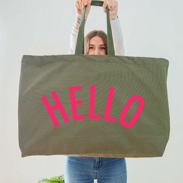 Really Big Oversized Olive Green Tote Bag With the Word 'HELLO' Printed In Big Letters In A Neon Pink Vinyl