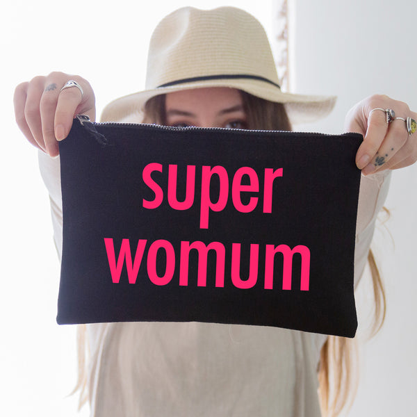 an oversized black cotton canvas pouch printed with the slogan 'super womum' in neon pink