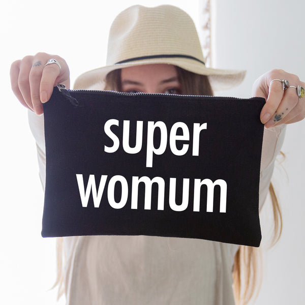an oversized black cotton canvas pouch printed with the slogan 'super womum' in white
