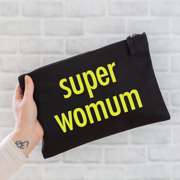 an oversized black cotton canvas pouch printed with the slogan 'super womum' in neon yellow